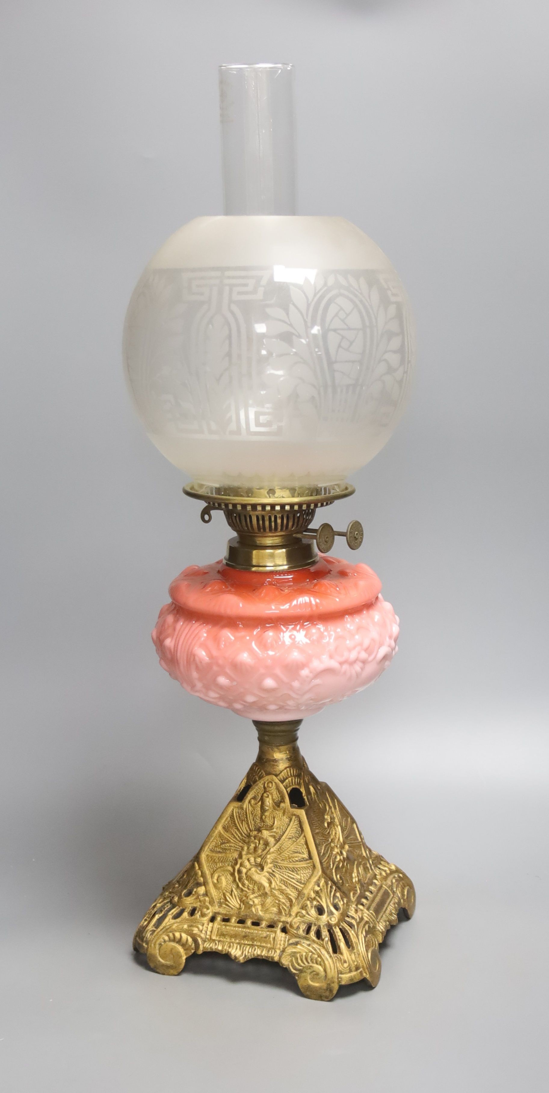 A Victorian cranberry glass and gilt metal oil lamp, with two shades, height 59cm